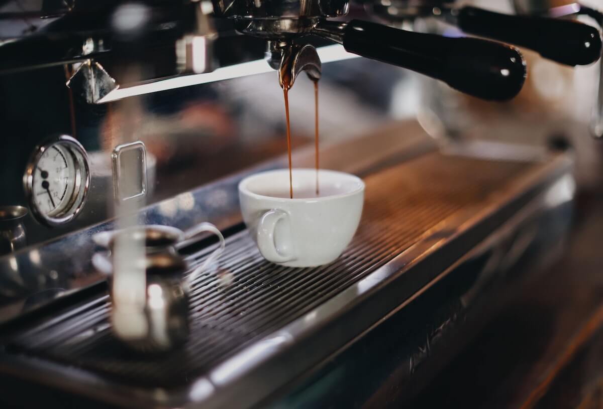 Closeup of an espresso machine pouring espresso into a cup